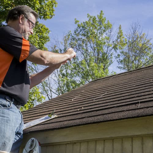 Adjuster inspects roof.