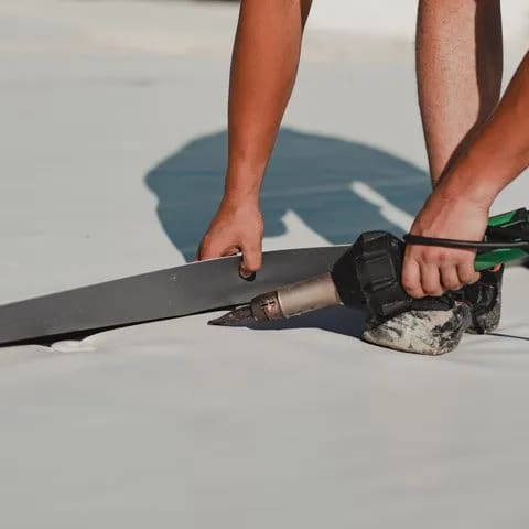 Roofer installs TPO.