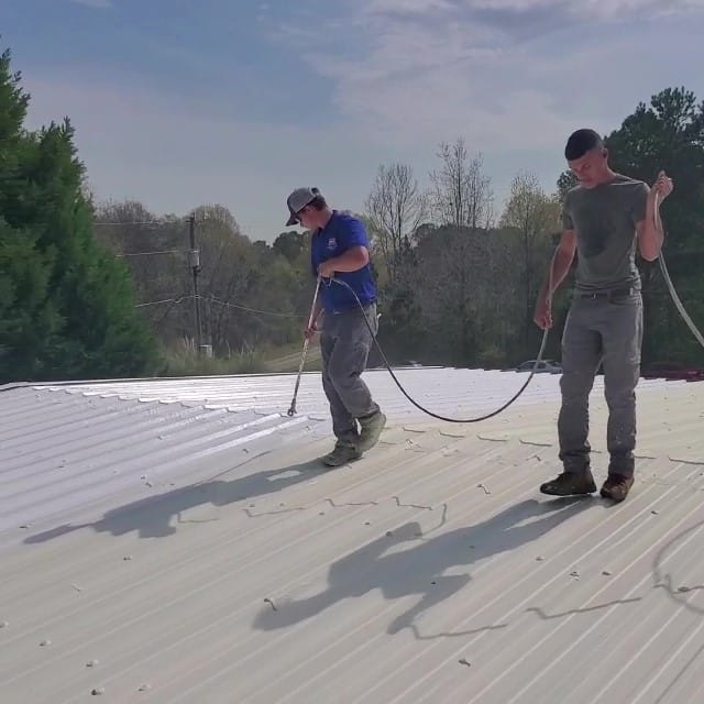 Contractor applies acrylic coating.