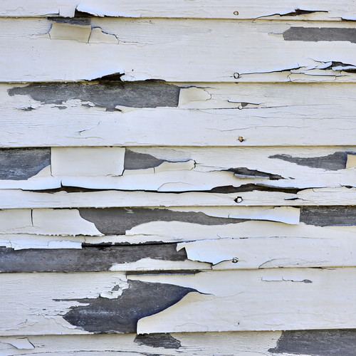 damaged siding on the side of a house