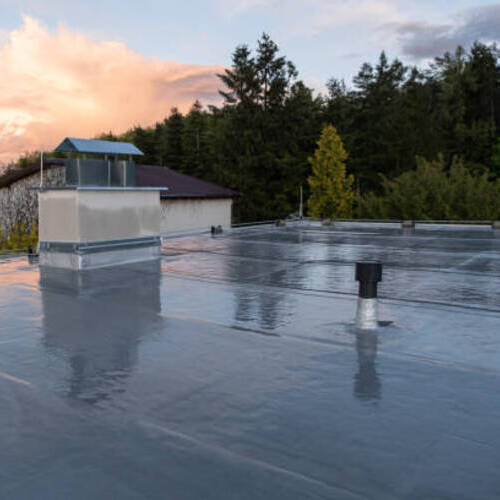 flat roof covered with bitumen membrane and silver lacquer coating