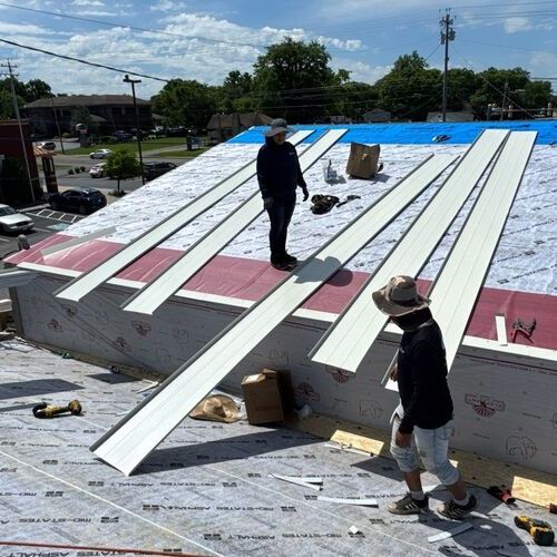 workers repairing a commercial metal roof