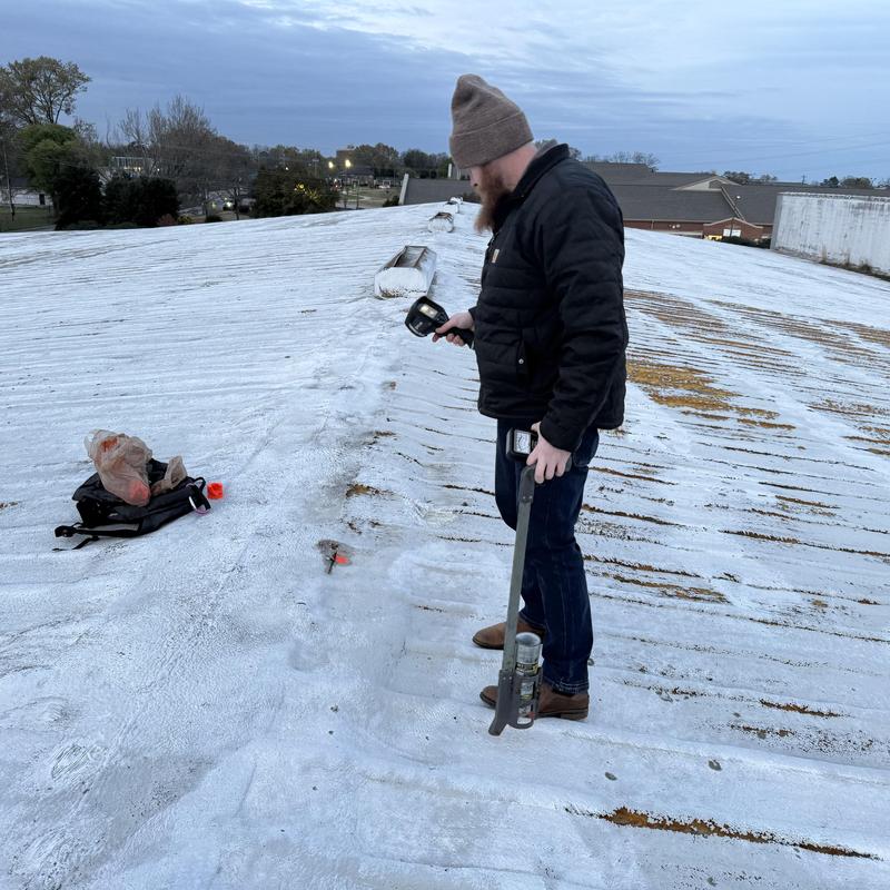 a man on a damaged metal roof
