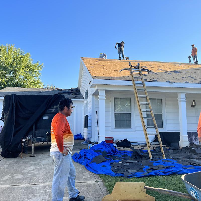 workers on a hail damaged roof