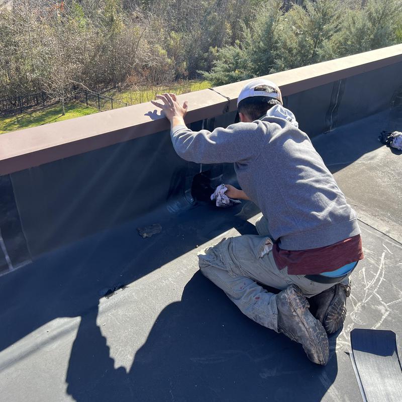 man working on an EPDM vulcanized rubber roof