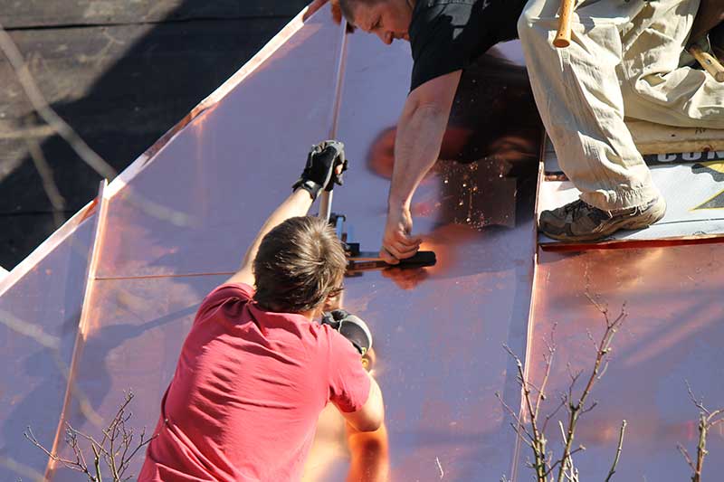 workers on copper metal roofing