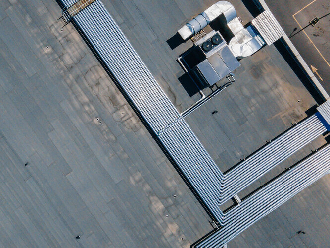 Chiller connected to air ducts on the roof of the building. Climate control. View from above