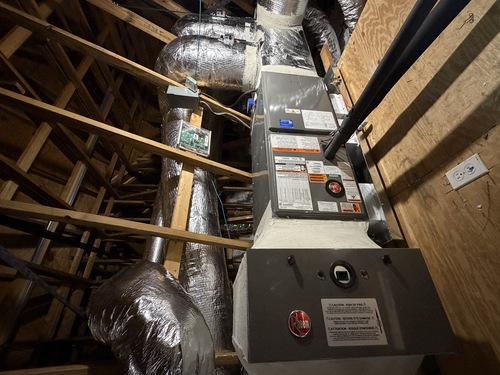 indoor HVAC unit sitting in an attic space