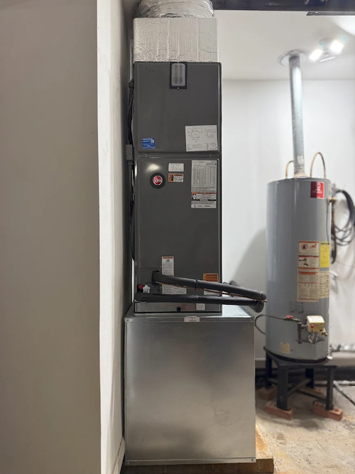 indoor air handler and furnace in a utility room