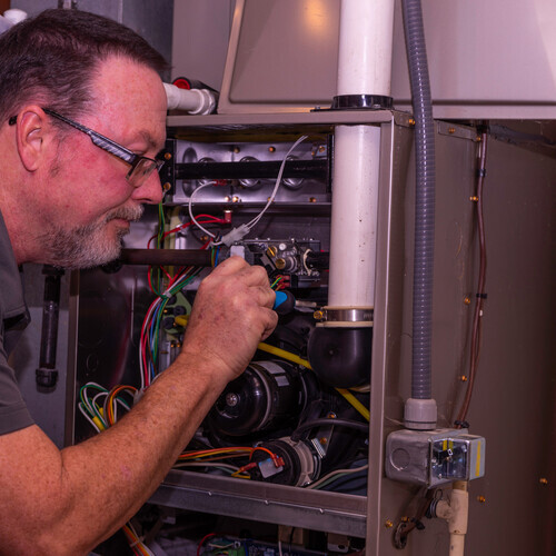 technician replacing a pressure switch