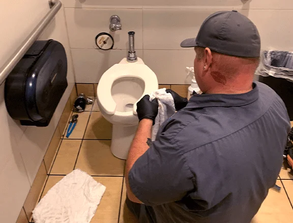 plumber providing toilet repair