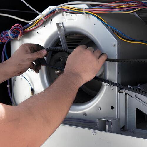 technician repairing an air conditioner blower