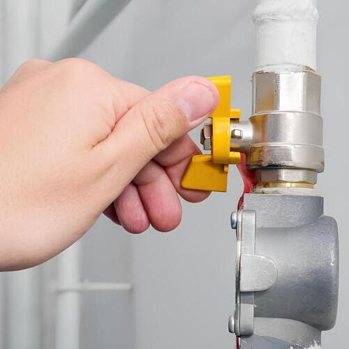 hand turning a gas valve