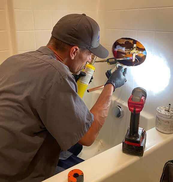 plumber repairing a shower faucet