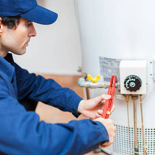 Plumber fixing an hot-water heater