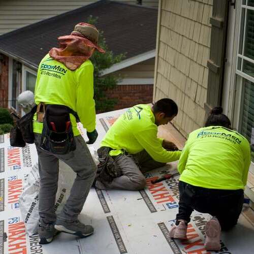 Roofers repair roof leak.