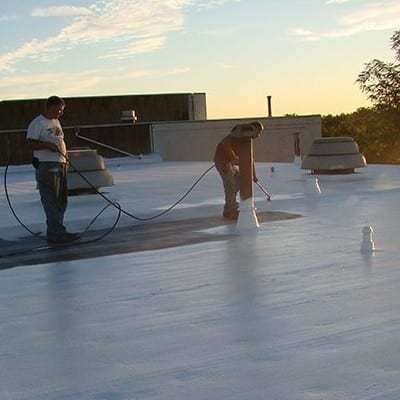 Roofers apply rubber roof coating.