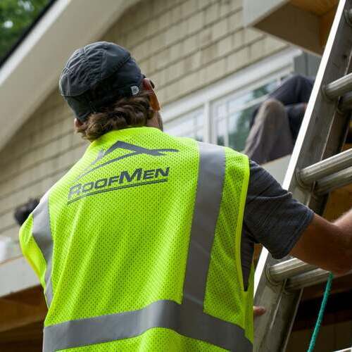 Roofer inspects wind damage.