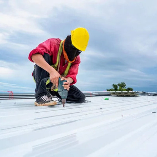 worker repairing a commercial roof