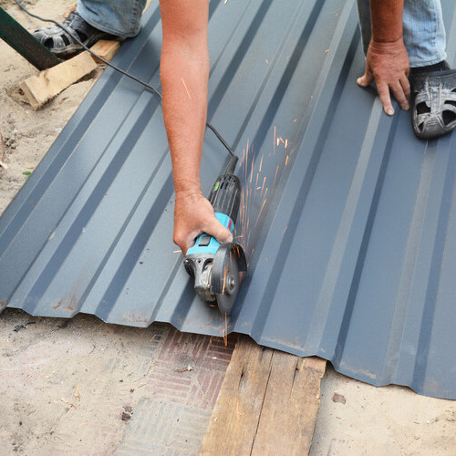 worker installing steel roofing