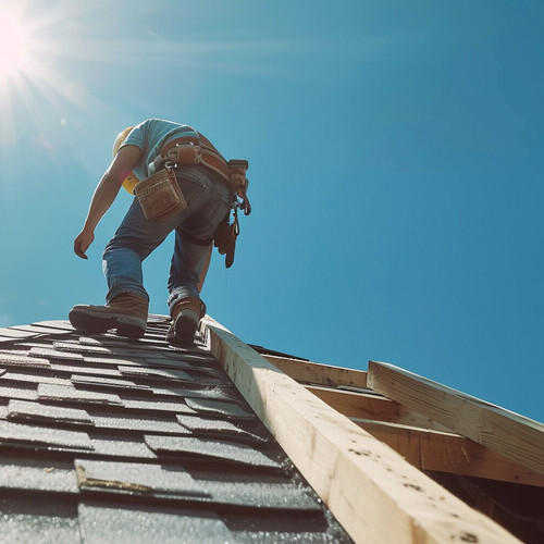 Construction worker on the roof of a house with a roof shingles