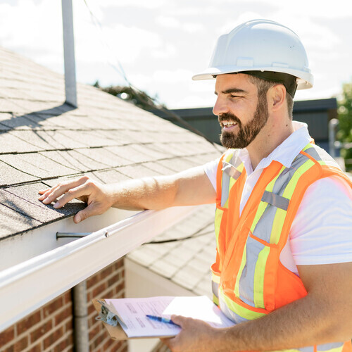 a roofer performing an inspection