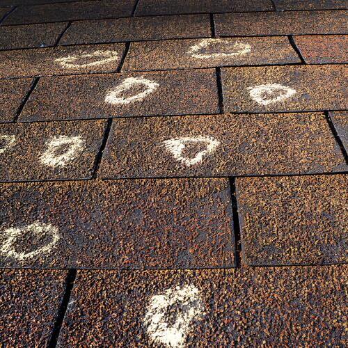 overhead view of damage marked on a roof