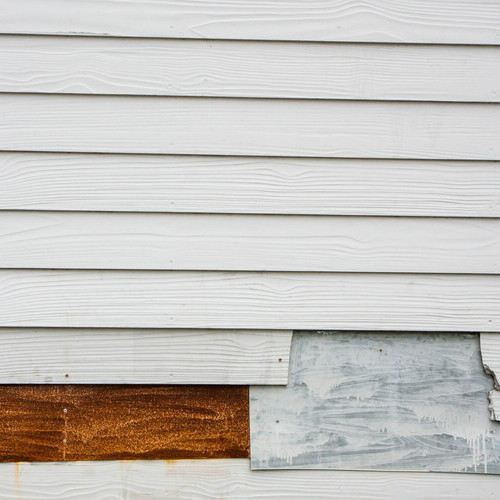 closeup of damaged siding