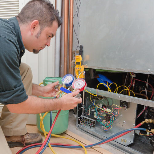 A Technician Tests an HVAC System.