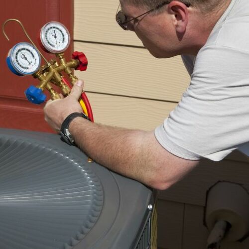 A Technician Tests an Air Conditioner.