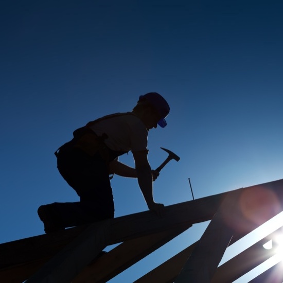 roofer silhouette making repairs on a roof