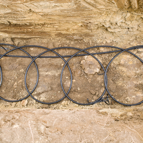 Geothermal coils in a trench