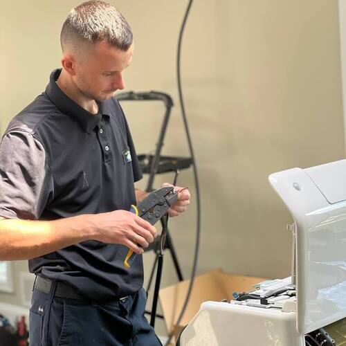 Technician works on electrical repair.