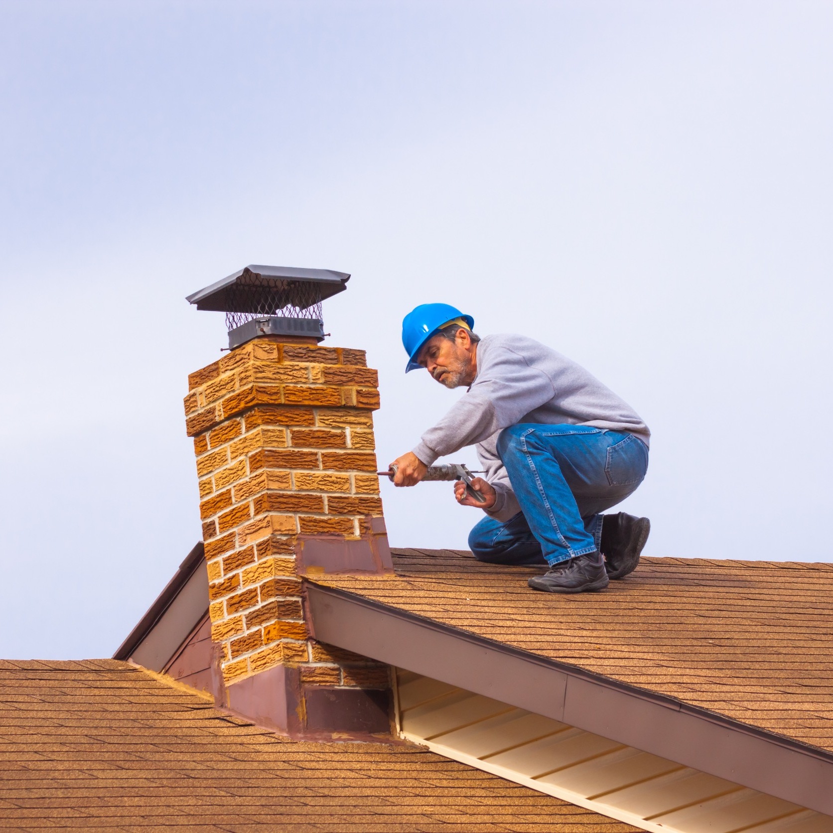 man on roof fixing a chimney