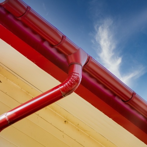 red gutters against blue sky